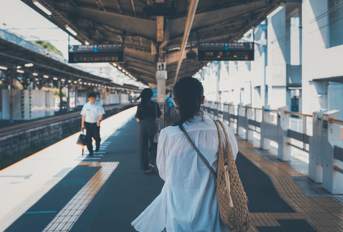 Commuters walking through Tokyo Station concourse during daylight hours, illustrating the busy foot traffic foreign tourists face